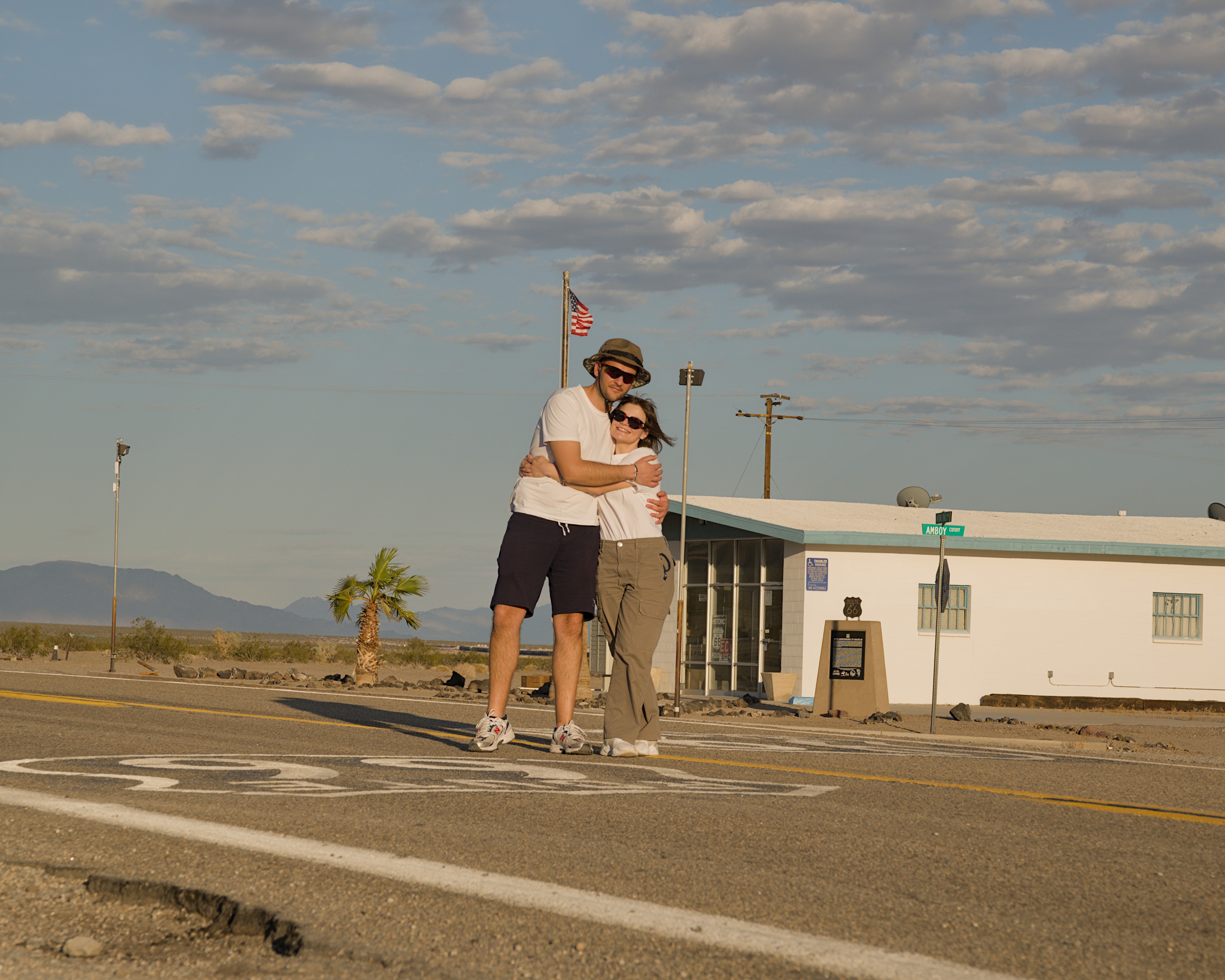The Italian couple poses in front of the Amboy post office